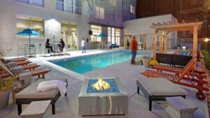 Modern poolside lounge with fire pit